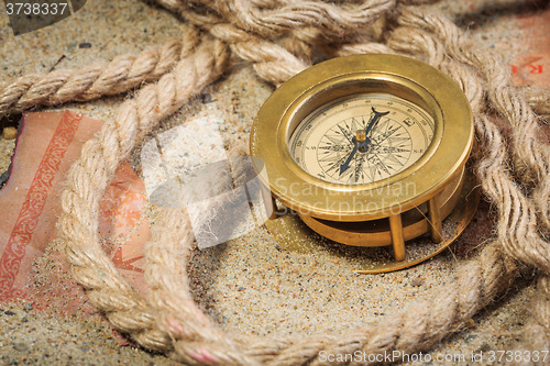 Image of set of nautical instruments, lying on the sand and old map. concept adventure