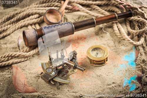 Image of set of nautical instruments, lying on the sand and old map. concept adventure