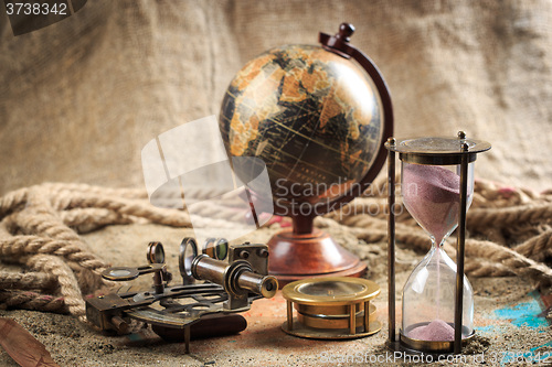 Image of set of nautical instruments, lying on the sand and old map. concept adventure