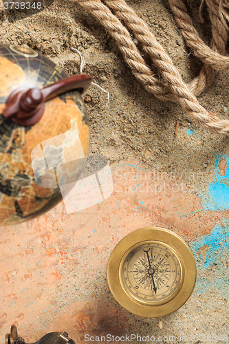 Image of set of nautical instruments, lying on the sand and old map. concept adventure