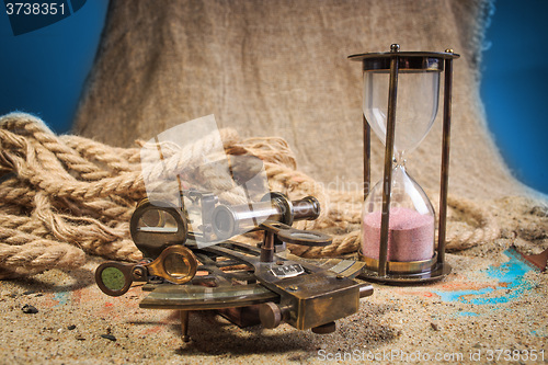 Image of set of nautical instruments, lying on the sand and old map. concept adventure