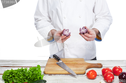 Image of Chef cooking fresh vegetable salad in his kitchen