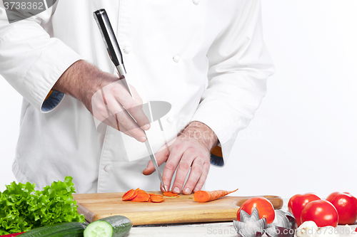 Image of Chef cooking fresh vegetable salad in his kitchen