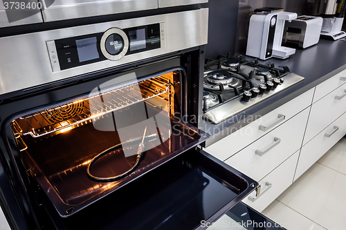 Image of Modern hi-tek kitchen, oven with door open