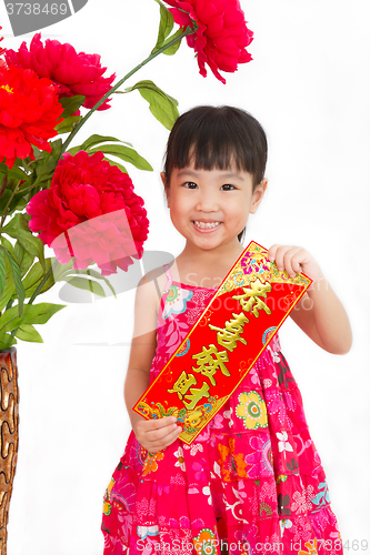 Image of Chinese little girl pising holding  Spring festival couplets