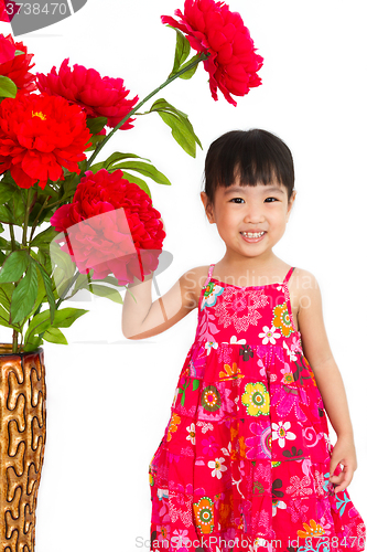 Image of Chinese little girl wearing in Red posing with flowers