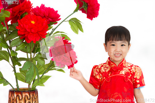 Image of Chinese little girl wearing in Red posing with flowers