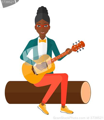 Image of Woman playing guitar.