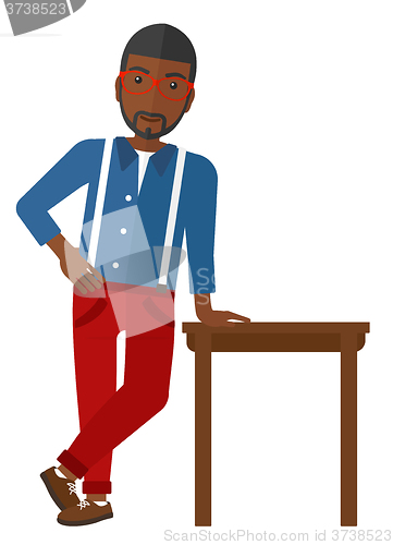 Image of Man leaning on table.
