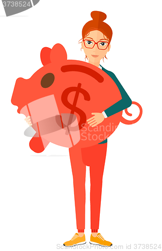 Image of Woman carrying piggy bank.