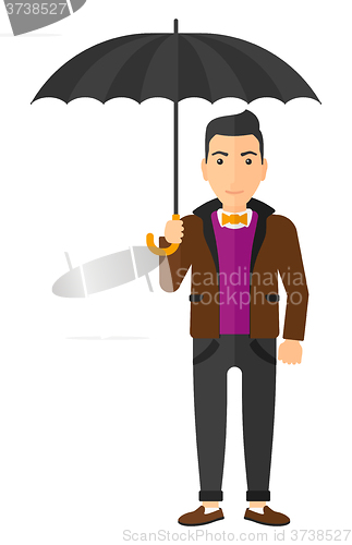 Image of Businessman standing with umbrella.