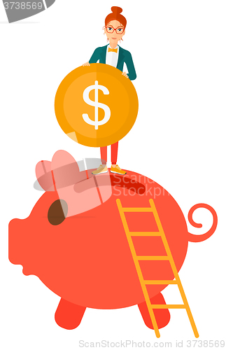 Image of Woman putting coin in piggy bank.