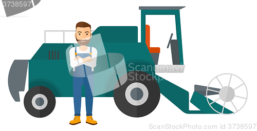 Image of Man standing with combine on background.