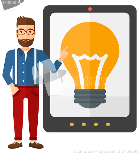 Image of Man pointing at tablet computer with light bulb on screen.