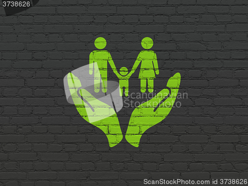 Image of Insurance concept: Family And Palm on wall background