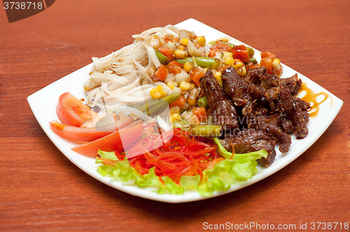 Image of chinese noodles with roasted meat and vegetables