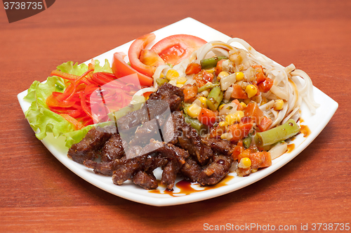 Image of chinese noodles with roasted meat and vegetables