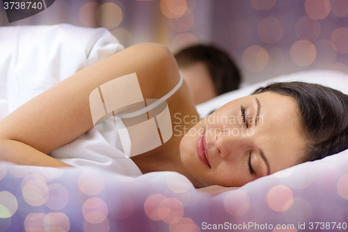 Image of happy couple sleeping in bed