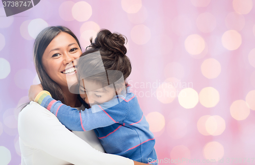 Image of happy mother and daughter hugging