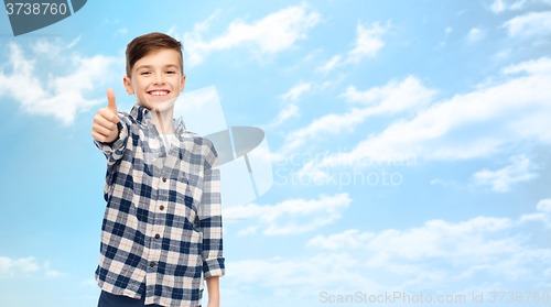 Image of smiling boy in checkered shirt showing thumbs up