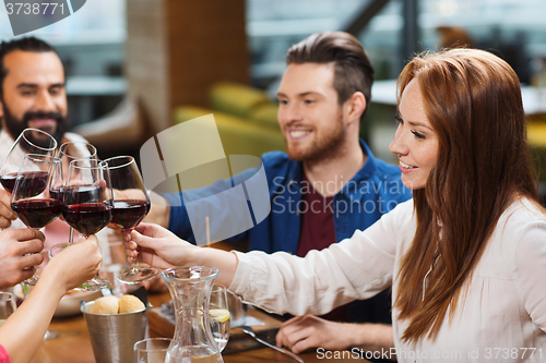 Image of friends dining and drinking wine at restaurant