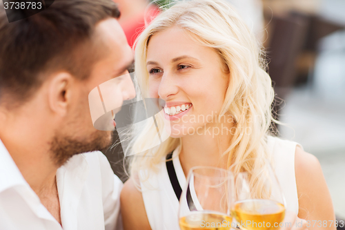 Image of happy couple clinking glasses at restaurant lounge