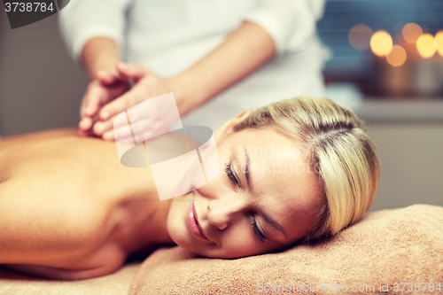 Image of close up of woman lying and having massage in spa