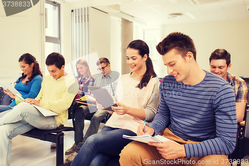 Image of group of smiling students with tablet pc