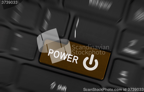 Image of Brown power button on a black laptop keyboard