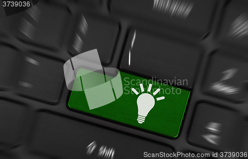 Image of Laptop keyboard with light bulb symbol