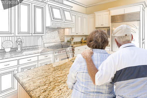 Image of Senior Couple Looking Over Custom Kitchen Design Drawing and Pho