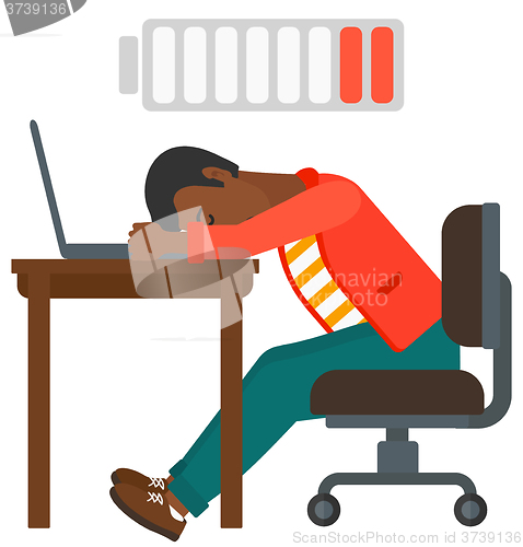 Image of Man sleeping at workplace.