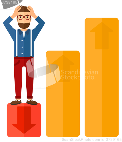 Image of Businessman standing on low graph.