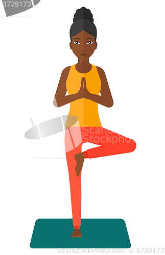 Image of Woman practicing yoga.