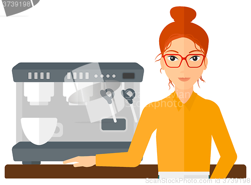 Image of Barista standing near coffee maker.