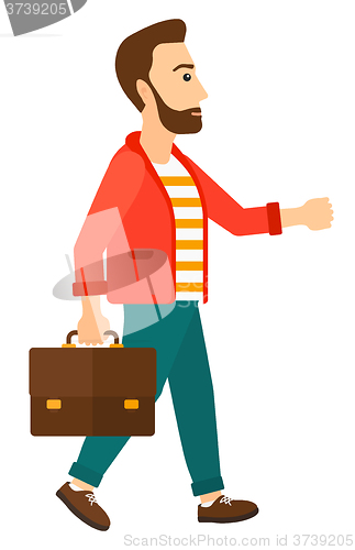 Image of Businessman walking with briefcase. 