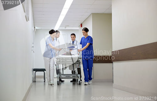 Image of medics and patient on hospital gurney at emergency