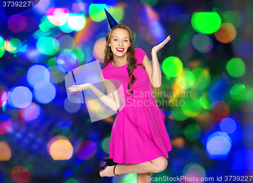 Image of happy young woman or teen girl in party cap