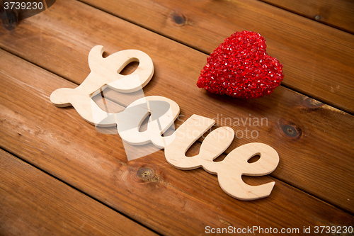 Image of close up of word love with red heart decoration