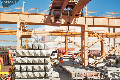 Image of Slinger on workplace. Loading of products. Crane works