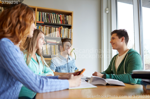 Image of students with books preparing to exam in library