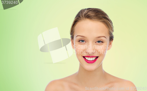 Image of smiling young woman face and shoulders