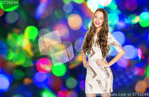 Image of happy young woman or teen girl over disco lights
