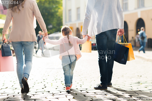 Image of close up of family with child shopping in city