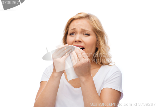 Image of unhappy woman with paper napkin sneezing