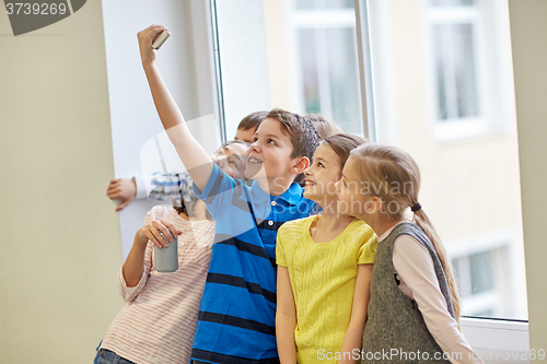 Image of group of school kids with smartphone and soda cans