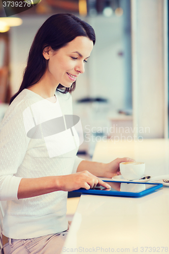 Image of smiling woman with tablet pc and coffee at cafe