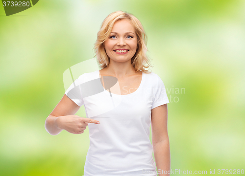 Image of smiling woman in white t-shirt pointing to herself