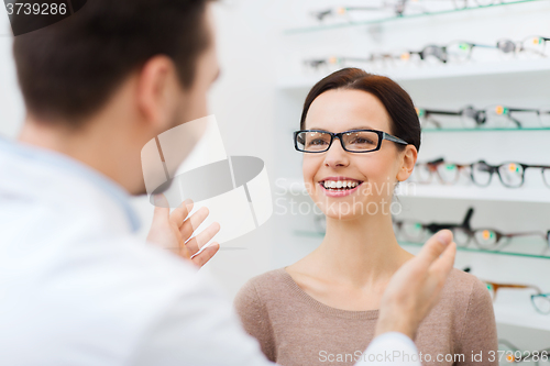 Image of optician and woman in glasses at optics store