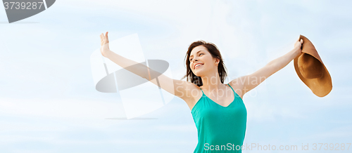 Image of girl in hat standing on the beach